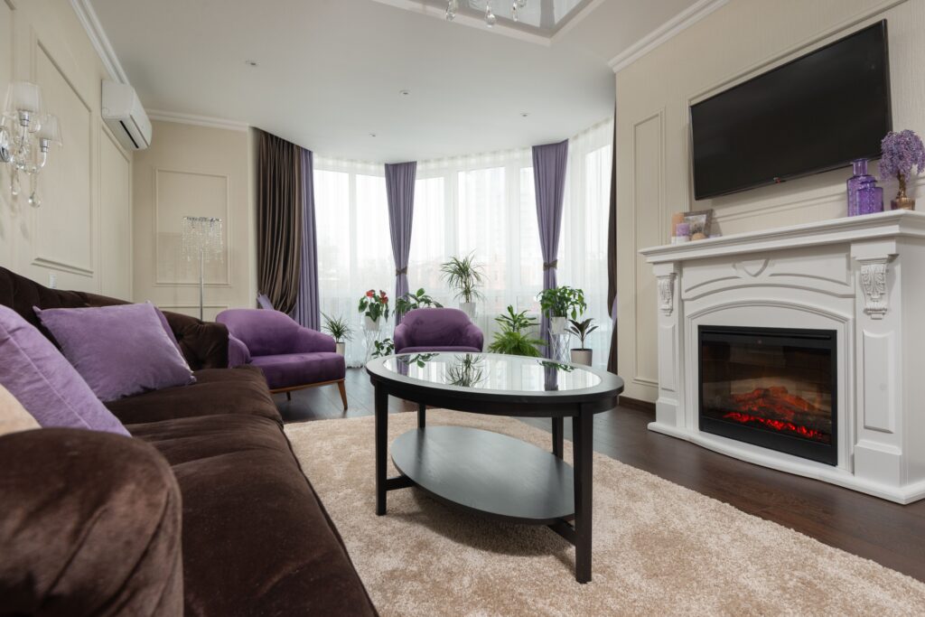 pexels photo 8135112 8135112 Cozy modern living room featuring a fireplace, plush furniture, and elegant decor.